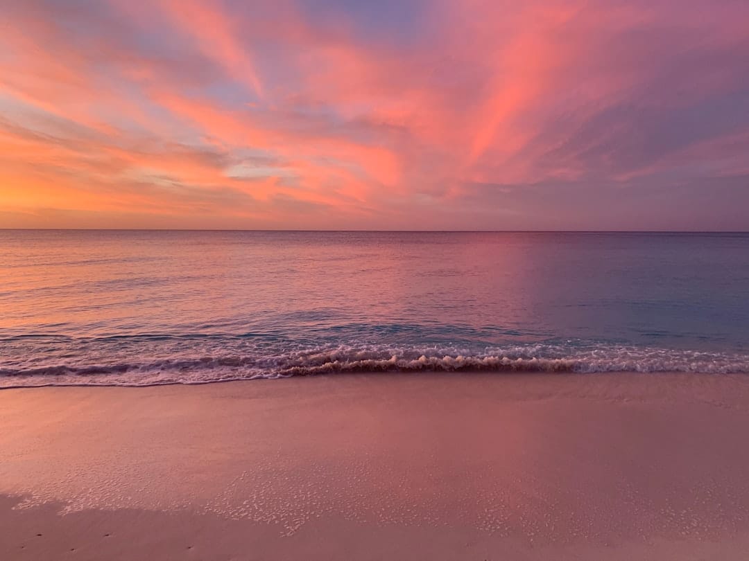 Photo by Taoh Nichols ocean waves crashing on shore during sunset