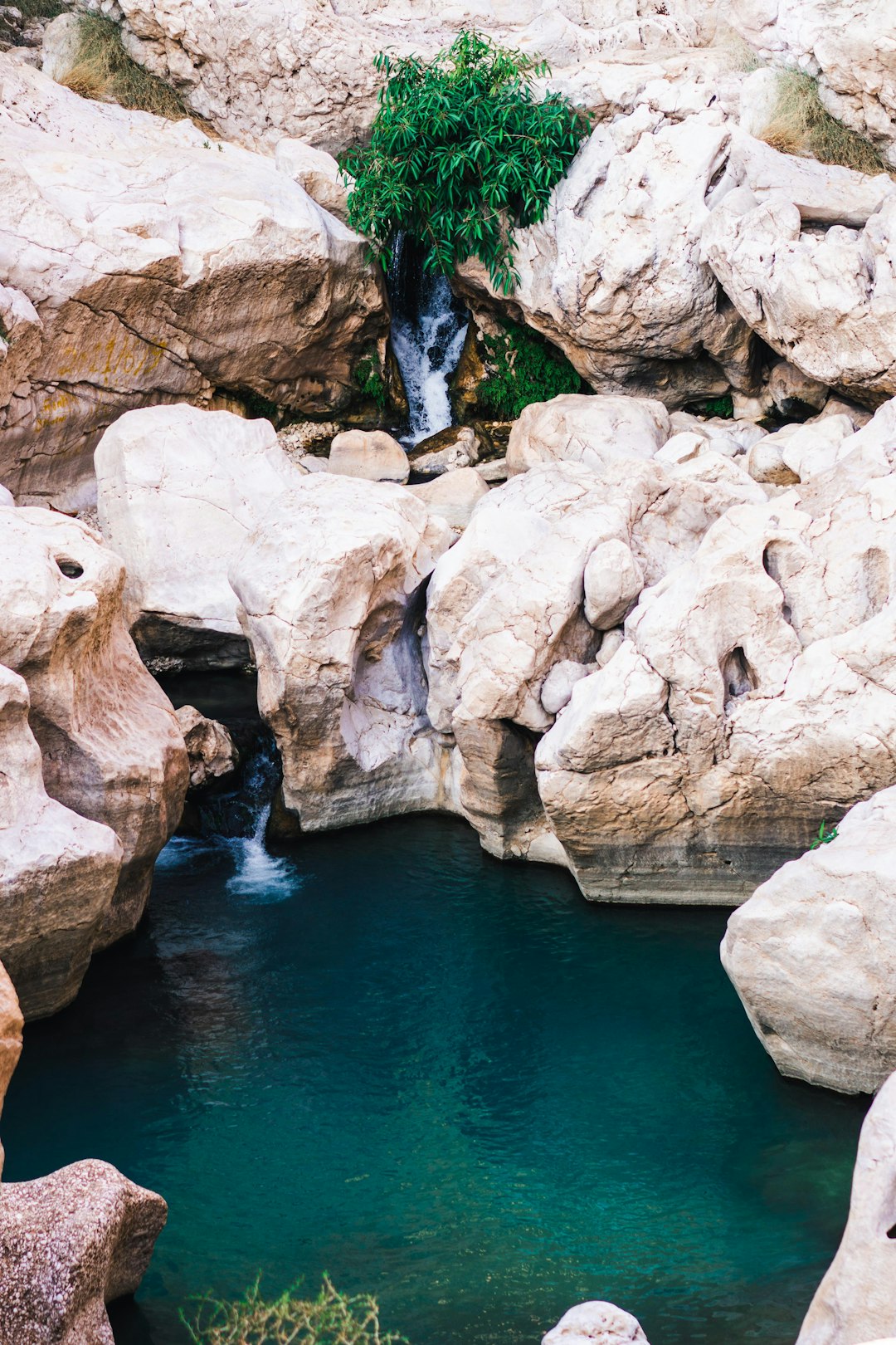 Photo by Silas Baisch brown rock formation beside body of water during daytime