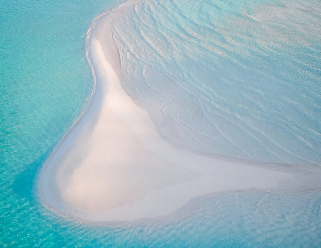 Photo by Ryan Geller white and blue ocean water