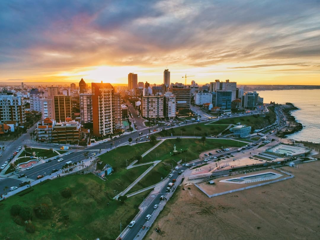Photo by Fermin Rodriguez Penelas aerial photography of high-rise building beside seashore during daytime