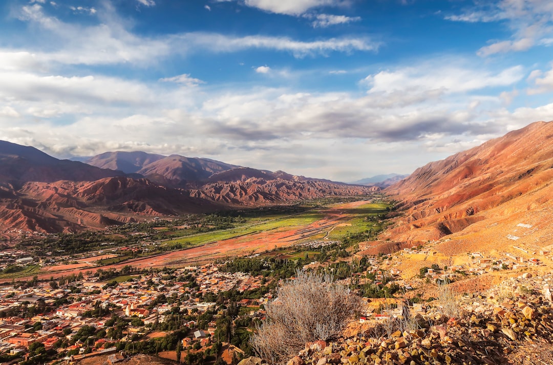 Photo by Hector Ramon Perez brown and green mountains under blue sky during daytime