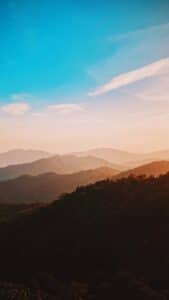 silhouette of mountains under blue sky during daytime