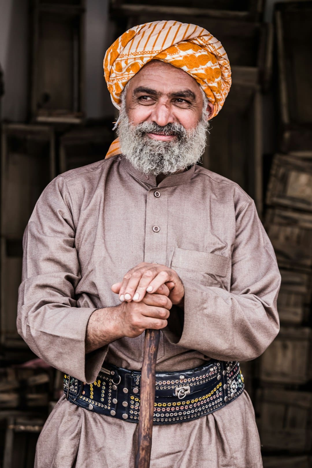 Photo by mohammad alashri man standing while holding brown wooden walking cane