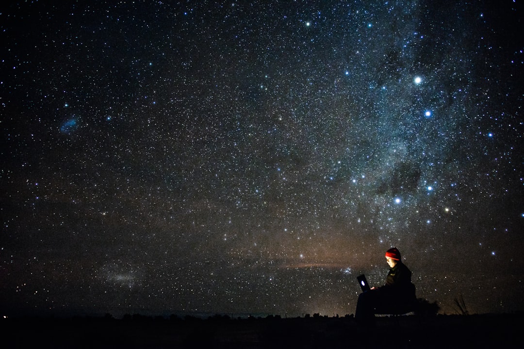 Photo by Johnson Wang human under starry night