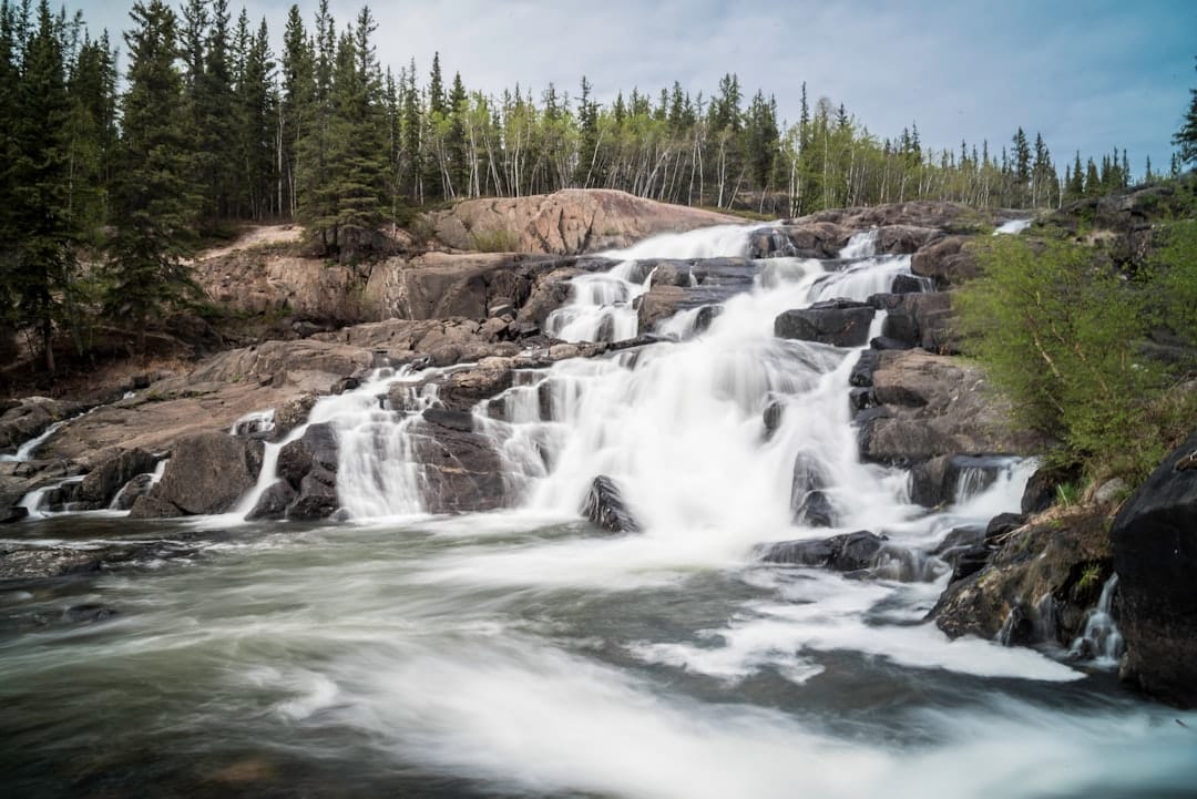 time lapse photography of flowing multi-step waterfall