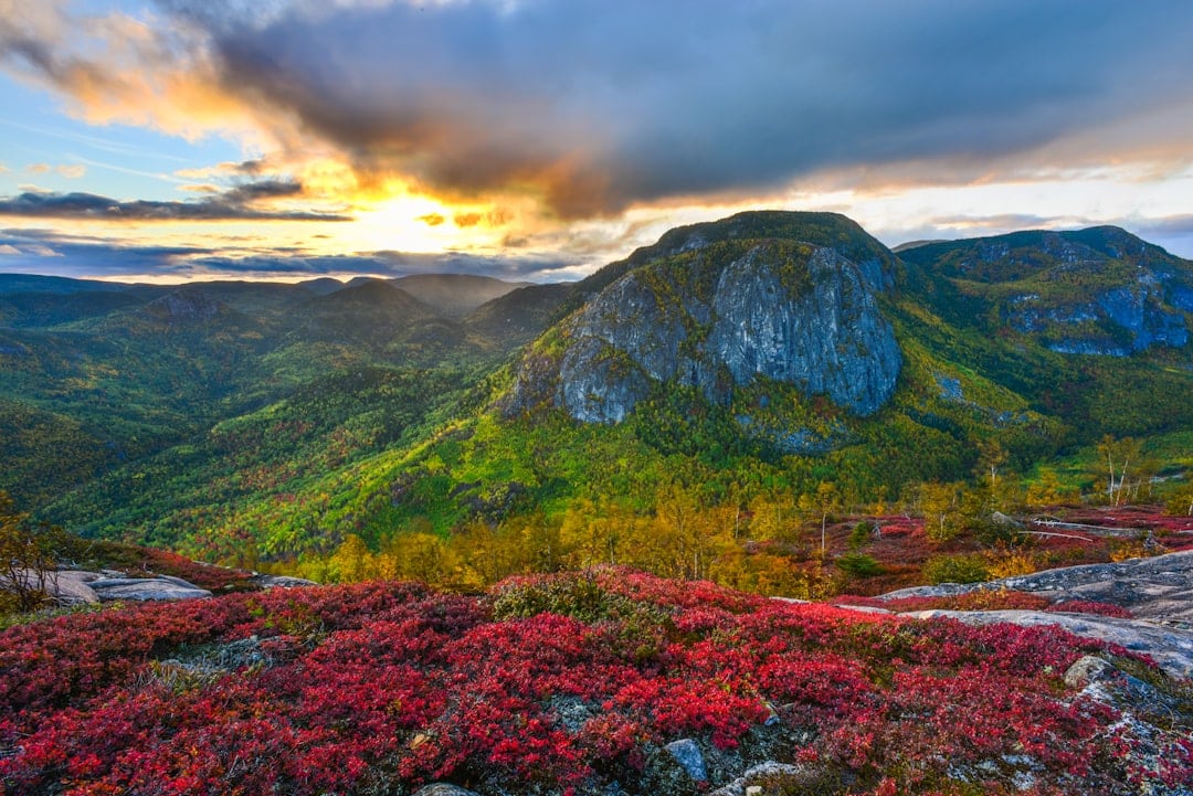 The sun is setting over a mountain range