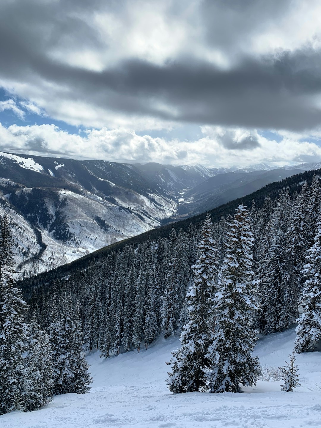 Photo by Bea de Ros snow covered mountain under cloudy sky during daytime