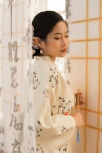a woman standing in front of a shower curtain